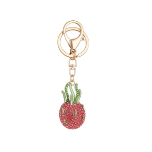 Sparkling pink rhinestone pitaya fruit keychain with gold hardware and green leaves