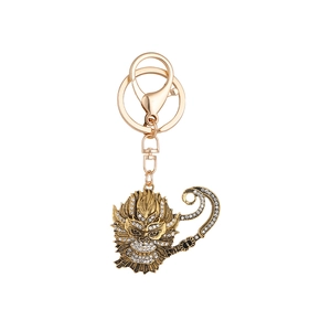 Golden Monkey King keychain with white rhinestones and a lobster clasp on white background