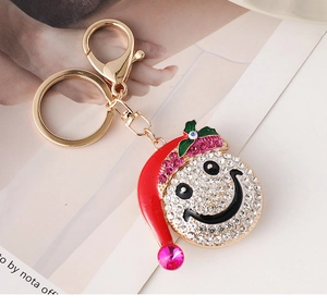 Detail of creative Christmas snowman smile keychain with sparkling crystals and red hat