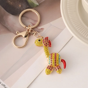 Portachiavi giraffa carina con cristalli colorati e finitura dorata su rivista di moda