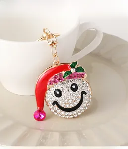 Close-up of sparkling rhinestone snowman hat keychain with golden lobster clasp detail