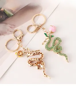 Detailed view of snake keychains with sparkling rhinestones and rose flower charms