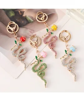 Detail of snake and rose keychains with crystal rhinestones in four elegant colors
