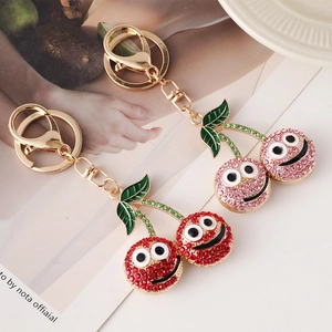 Creative cherry rhinestone keychains in red and pink with smiling cartoon faces and gold rings