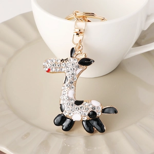 Eleganter Giraffen-Schlüsselanhänger mit Kristallen und Emaille auf einer Tasse
