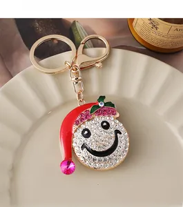 Detail of Christmas snowman keychain with sparkling rhinestones and red hat charm