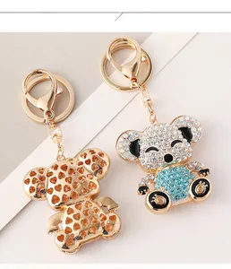 Detailed close-up of hollow gold-tone and rhinestone-encrusted koala keychains