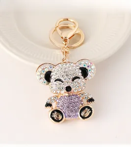 Detailed view of a gold-tone teddy bear keychain with sparkling crystals and lobster clasp