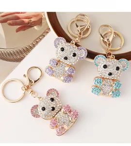 Close-up of bear keychains with colorful rhinestones and gold-plated metal clips