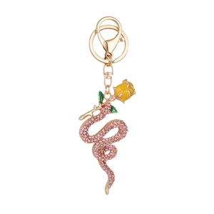 Rose and snake keychain with pink crystals and yellow flower on golden metal ring