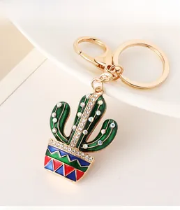 Detail shot of green cactus keychain with sparkling white rhinestones and a gold spring clasp
