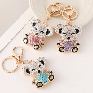 Sparkly crystal koala keychains in pink, purple, and blue with gold metal base