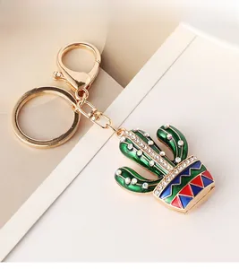 Detailed close-up of a cactus keychain with enamel finish and sparkling rhinestones