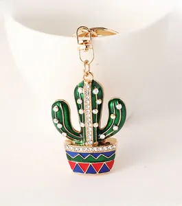 Detail of green cactus keychain with sparkling rhinestones and golden metal ring