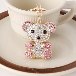 Sparkly rhinestone teddy bear keychain with pink and white crystals on golden alloy ring