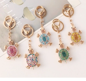 Detailed view of turtle keychains in five colors with sparkling crystal rhinestones