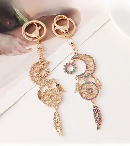 Detailed macro view of golden crescent moon dreamcatcher keychain with multicolor rhinestones