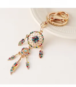 Macro shot of dreamcatcher keychain with colorful rhinestones and gold feathers