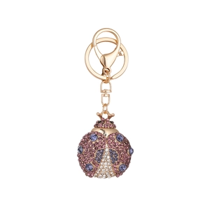 Sparkling crystal beetle keychain in gold finish with purple and blue rhinestones