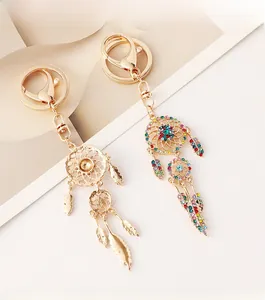 Detailed macro view of dreamcatcher keychains with colorful rhinestones and gold finish