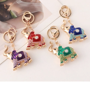 Detailed view of four colorful rhinestone elephant keychains with enamel decoration