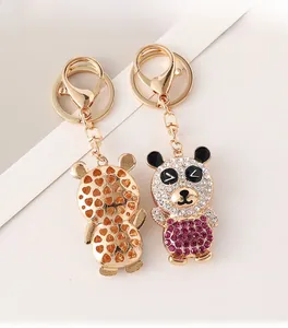 Macro detail of rhinestone panda keychain showing hollow heart back and polished gold finish