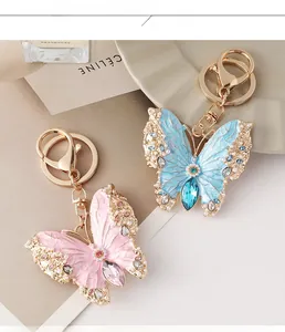 Detailed close-up of colorful enamel butterfly keychains with crystal and pearl accents