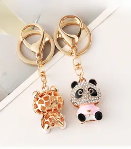 Detail of cute panda keychain with white rhinestones and hollow golden honeycomb back