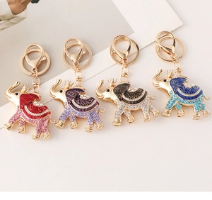 Close-up of four crown elephant keychains with colorful crystals and enamel plating
