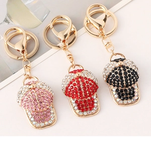 Detailed macro view of rhinestone baseball cap keychains in pink, red, and black colors
