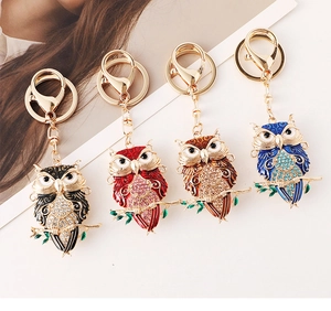 Set of four colorful owl keychains with crystals and enamel in black red brown and blue