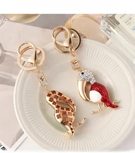 Detailed macro view showing the front enamel and textured gold back of the toucan keychain