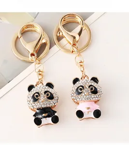 Close-up of gold-plated panda keychains with sparkling rhinestones and colorful enamel