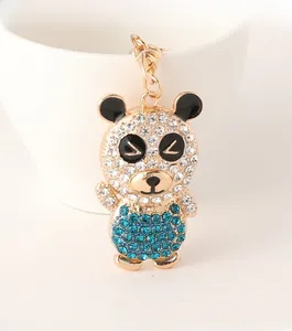 Detailed close-up of a golden panda keychain featuring blue and white rhinestones