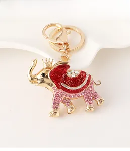 Detail of a gold crown elephant keychain with red enamel and sparkling rhinestones