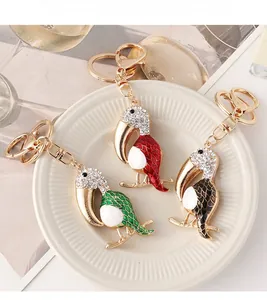 Three rhinestone encrusted toucan keychains in red black and green enamel finish