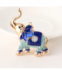 Detailed macro shot of an elephant keychain with blue enamel and sparkling rhinestones