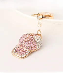 Close-up of baseball cap keychain with sparkling pink and white rhinestones and gold ring