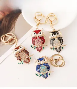 Detail showing various colors of owl keychains with colorful enamel and crystals