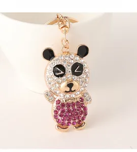 Macro shot of cute rhinestone panda keychain with gold lobster clasp and white gems