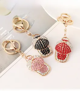 Close-up of sparkling rhinestone baseball cap keychains in red, pink, and black colors