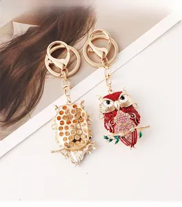 Detail view of owl keychain showing pink crystal front and hollow honeycomb metal back
