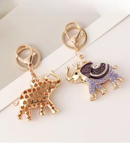 Detailed view of crown elephant keychains with purple enamel and sparkling crystal accents