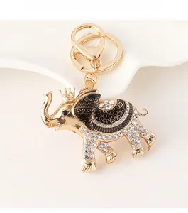 Detailed close-up of a sparkling crown elephant keychain with white rhinestones and black enamel