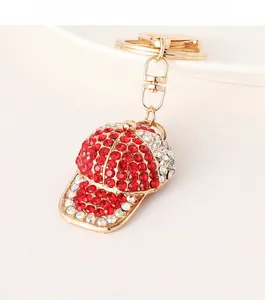 Detailed macro view of red and white rhinestones on a gold baseball cap keychain charm
