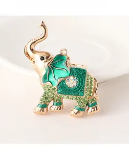 Macro shot of green rhinestone elephant keychain with gold plating and enamel ears