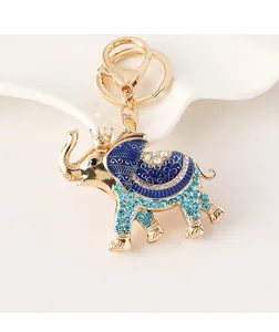 Detail view of golden elephant keychain with blue enamel and sparkling rhinestones