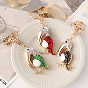 Three colorful toucan bird keychains with sparkling rhinestones and gold alloy rings