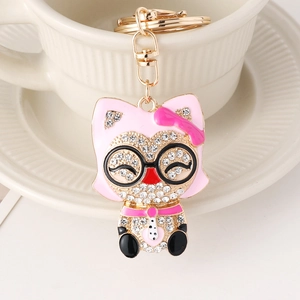 Porte-clés chaton avec strass et nœud rose en alliage de zinc doré pour sac à main