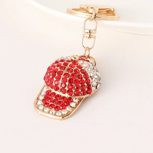 Baseball cap keychain with red and white rhinestones on a gold metal lobster clasp